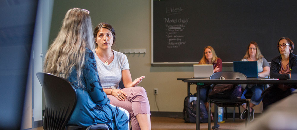 2 female students role playing in counseling class