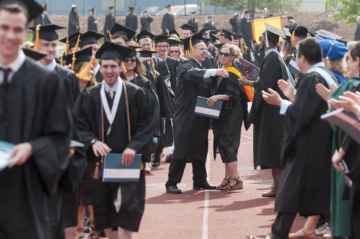 Students wearing graduation gowns during commencement 2015