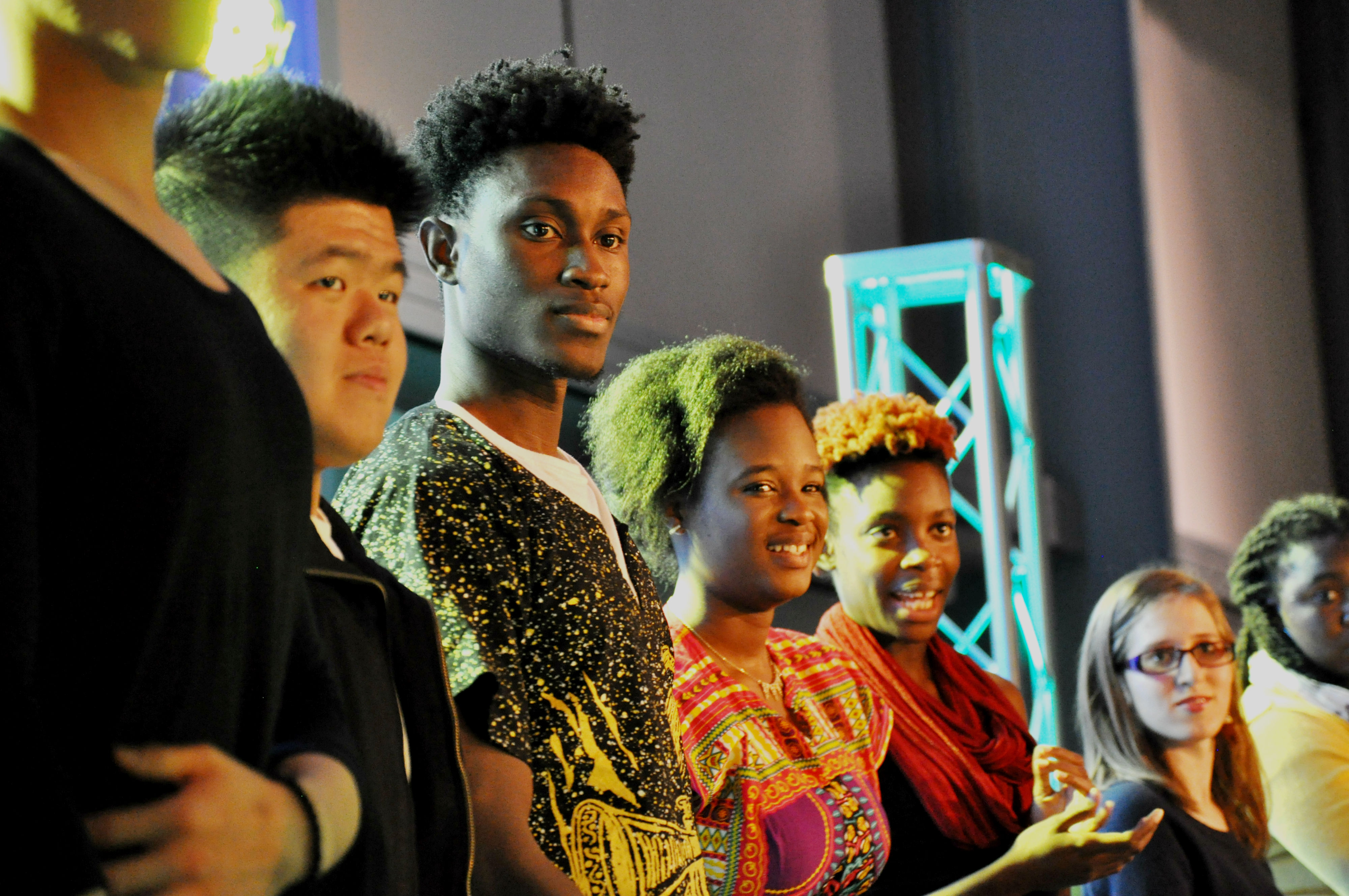 Students stand on stage at a multicultural event