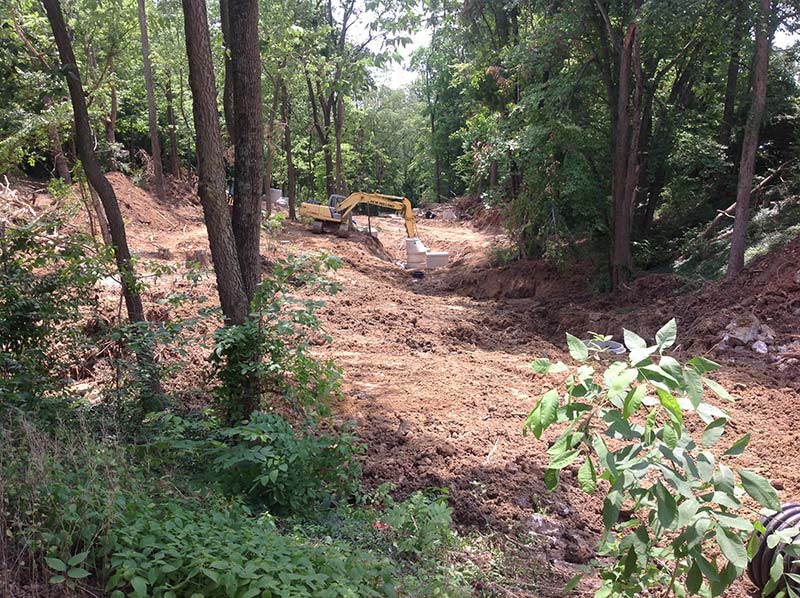 A fork crane unearthing the ground during the ravine restoration process