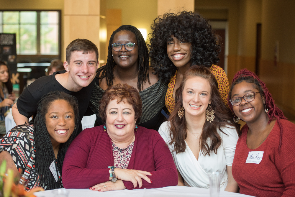 President Phipps sitting with several students