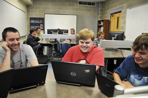 students working on laptops in lab