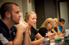 Students sitting at classroom table discussing