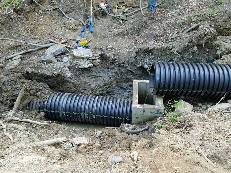 Pipe installation process during ravine restoration