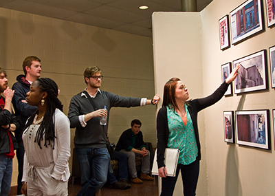 Students watching an art exhibition at the High Center.