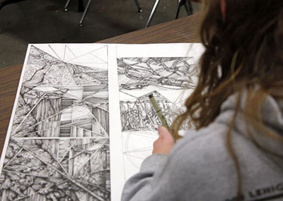 Student drawing two dimensional art.