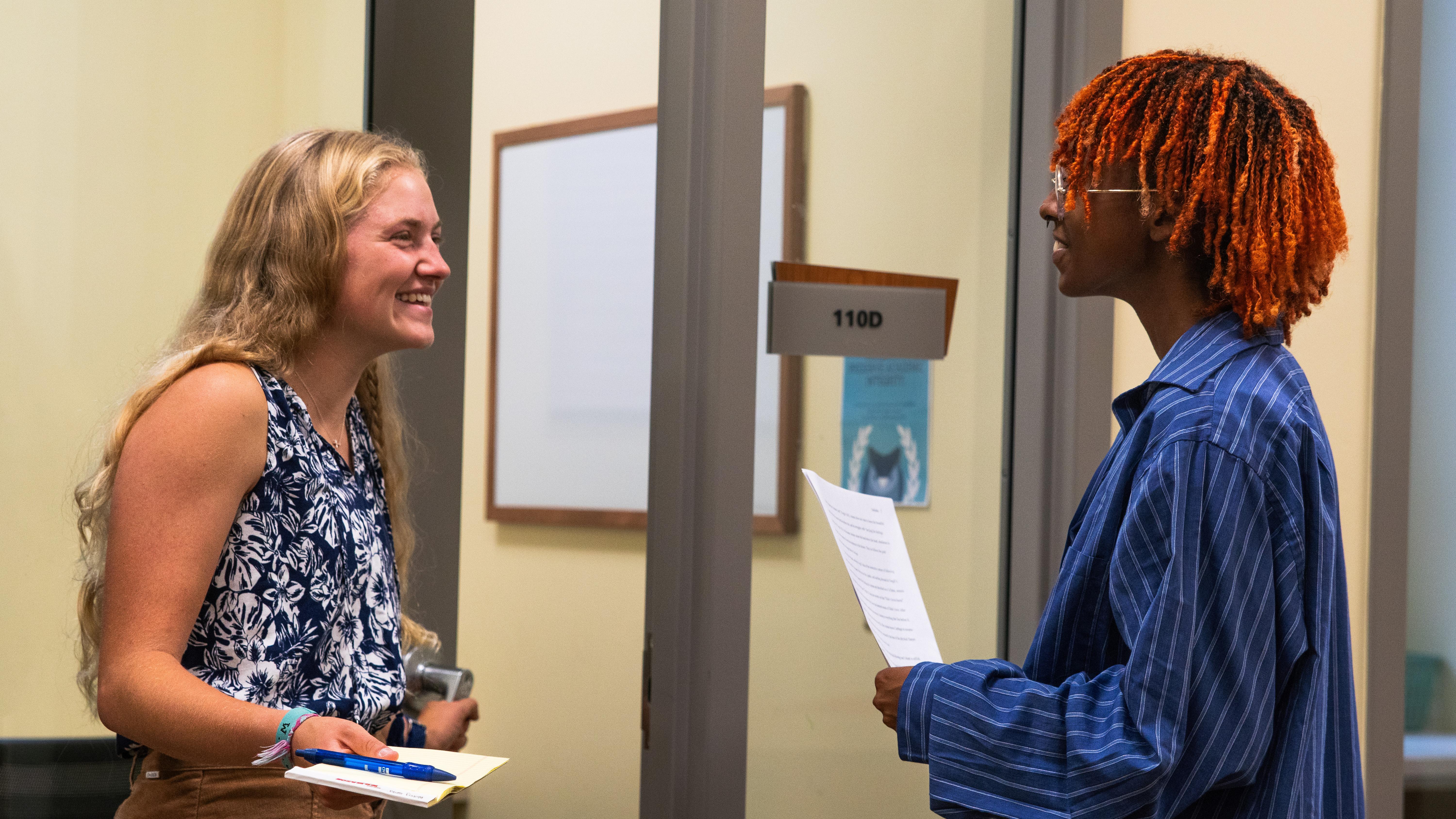 Writing Center tutor greets client.