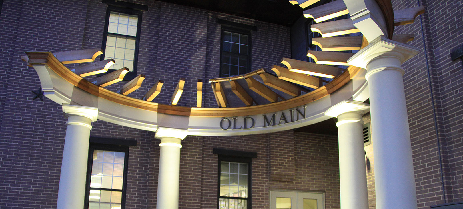 Finance & Planning  The entrance of Old Main Office Building which is lit up at night.jpg