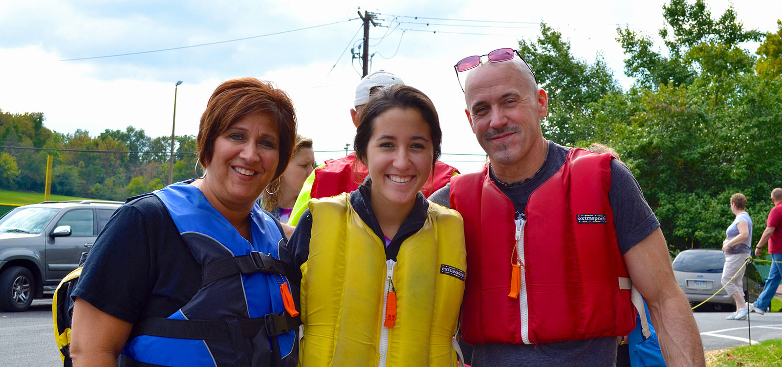 Parent and Family Relations parents with their daughter wearing a lifevest prior to canoeing.jpg