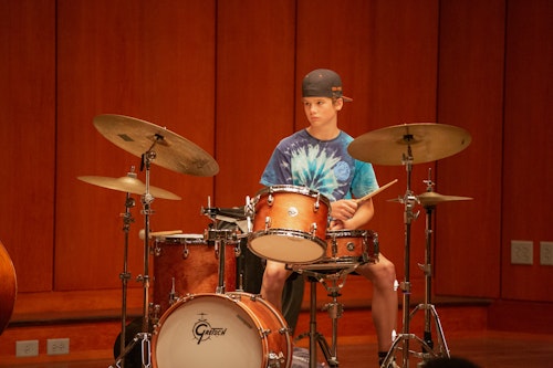 A student drummer at camp 