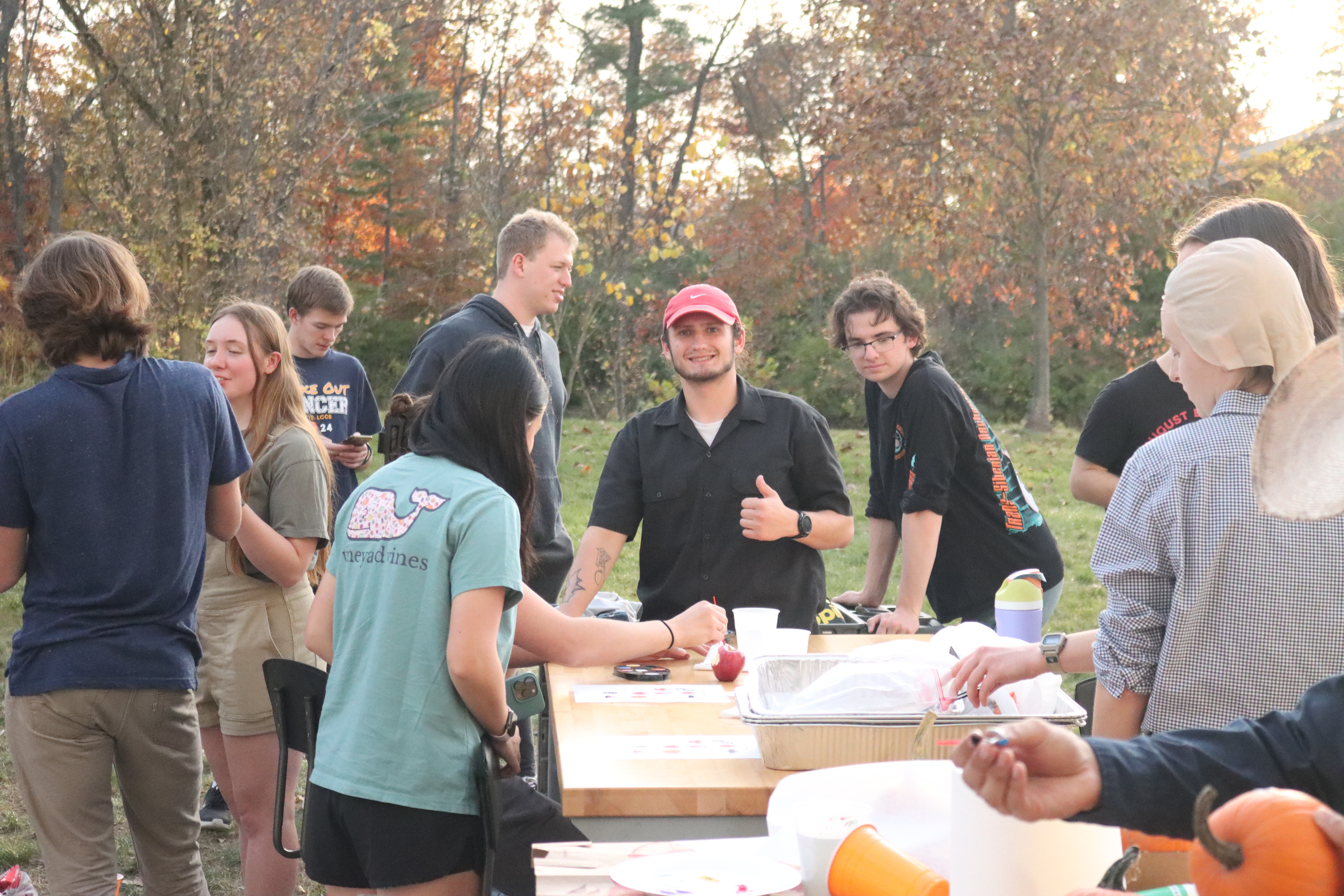Students laugh and smile at fall harvest event