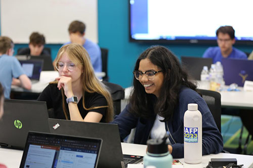 wo female cyber campers at their computers