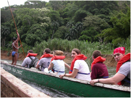 Students in a boat traveling to tribal village Embera