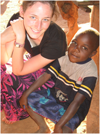 Female student sitting with an African child