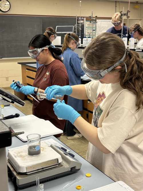 Students conducting experiments in chemistry lab