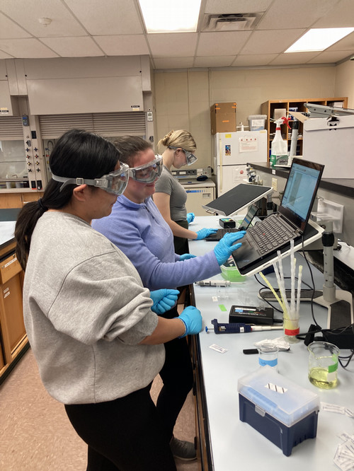 Three students in a biochemistry lab