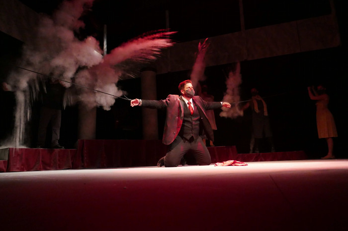 Performers on stage during the production of Antigone.