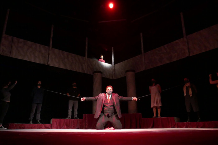 Performers on stage during the production of Antigone.