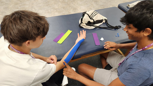 Students applying kinesio tape