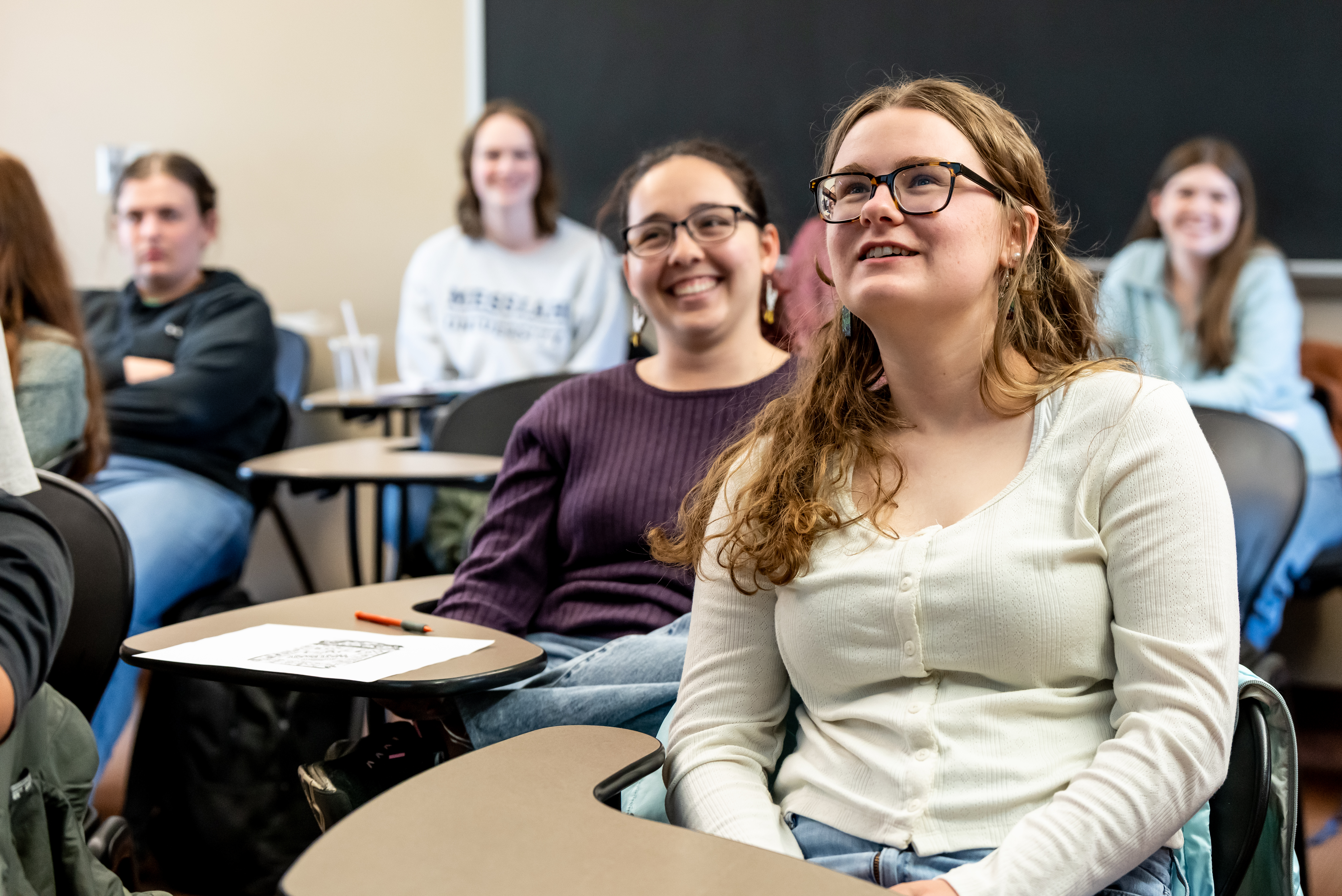 Students in classroom smiling