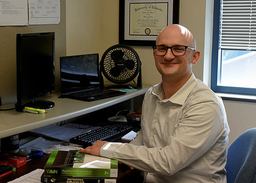 picture of employee sitting at desk with computer
