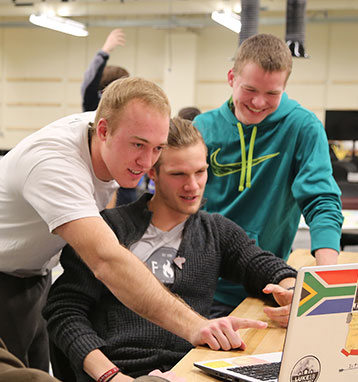 Three students working in new facilities