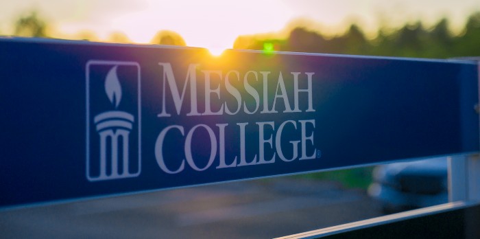 Messiah College sign with a sunset in the background