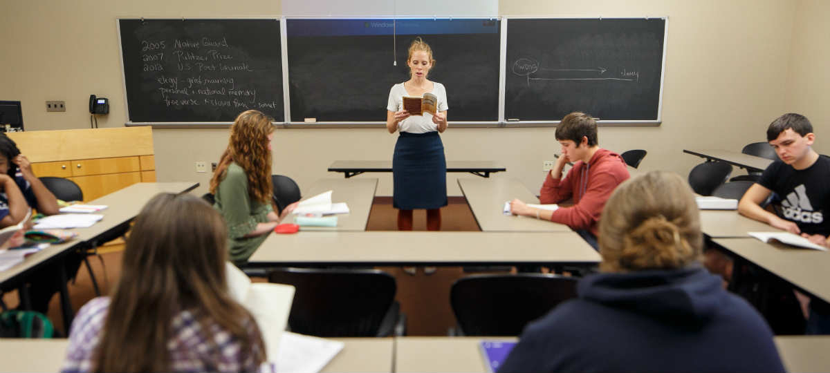 Teacher in front of classroom, instructing students