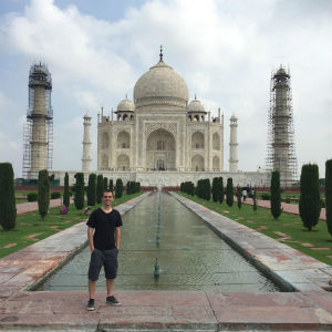 MaGuire standing in front of the Taj Mahal