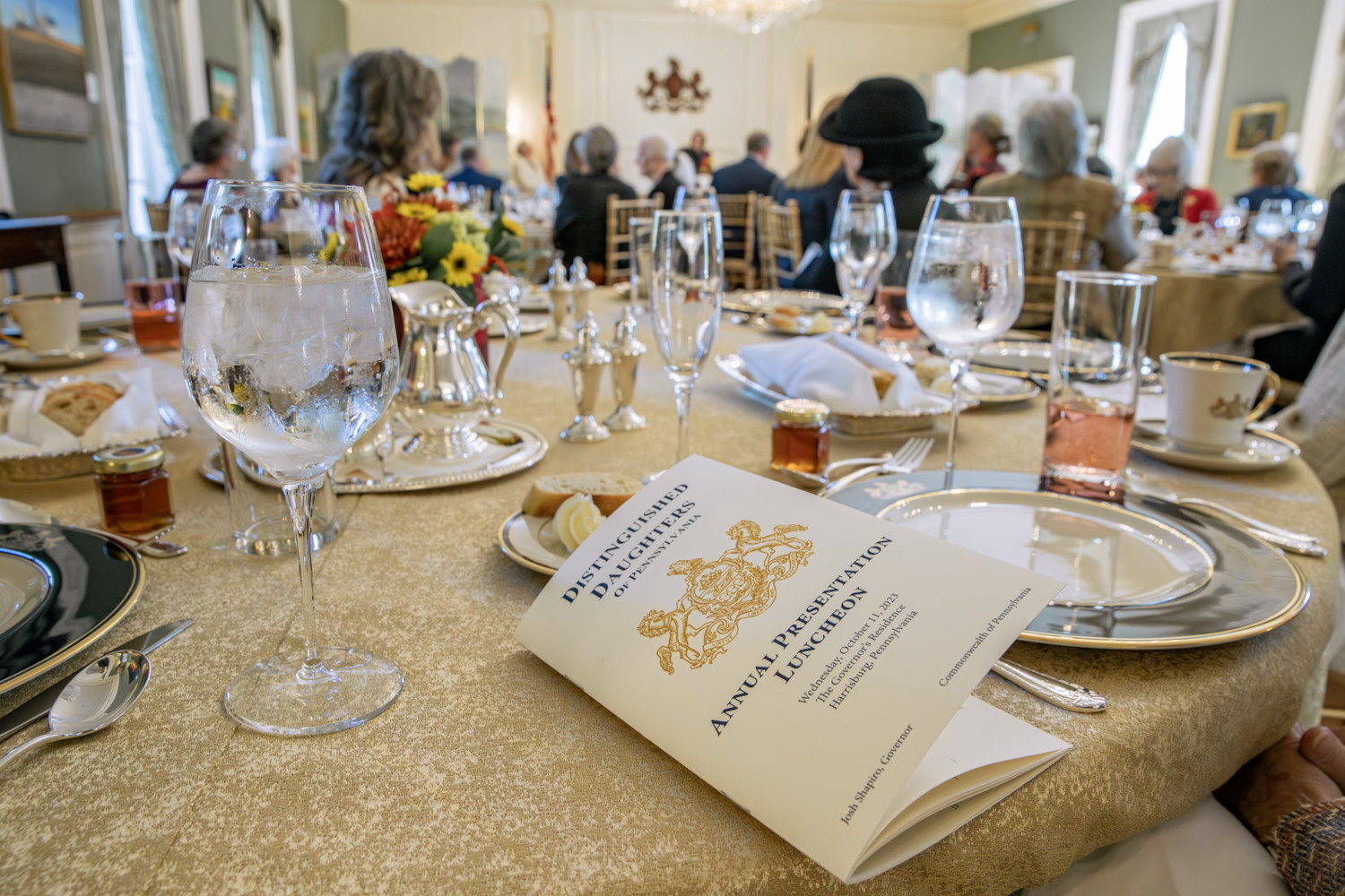 Place settings at the Distinguished Daughters of Pennsylvania luncheon. The event program is seen in the foreground.