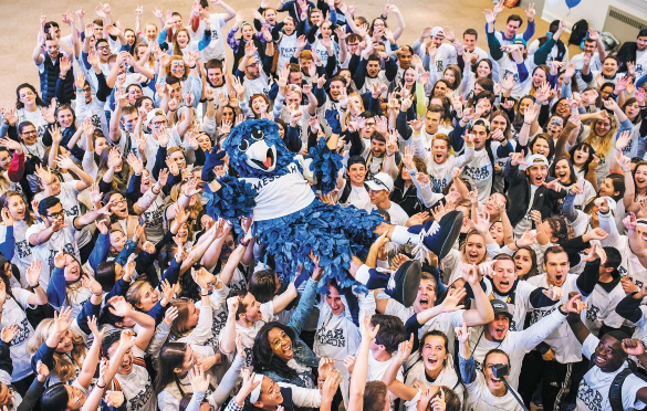 Photo of students holding mascot