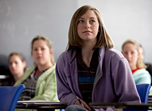 A female student, listening attentively in class.
