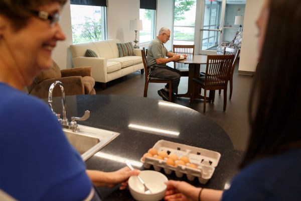 patients inside the ADL apartment work with OT staff