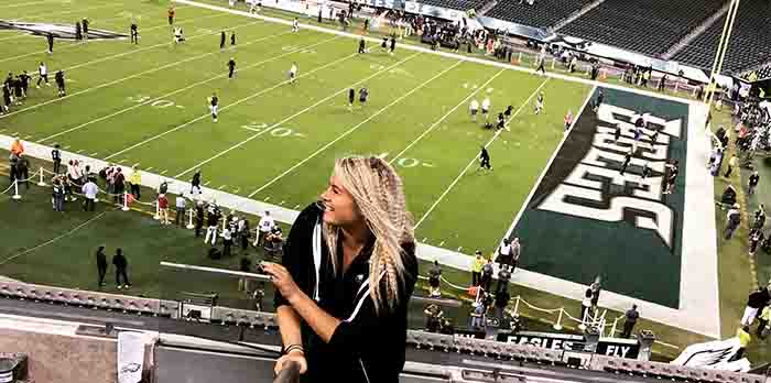 Alumna Bre Grignano working at the Philadelphia Eagles game.