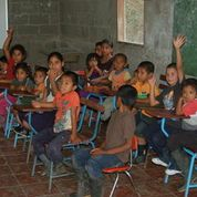 A group of children coffee roasters, sitting in class.