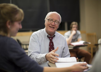Smiling professor working with student