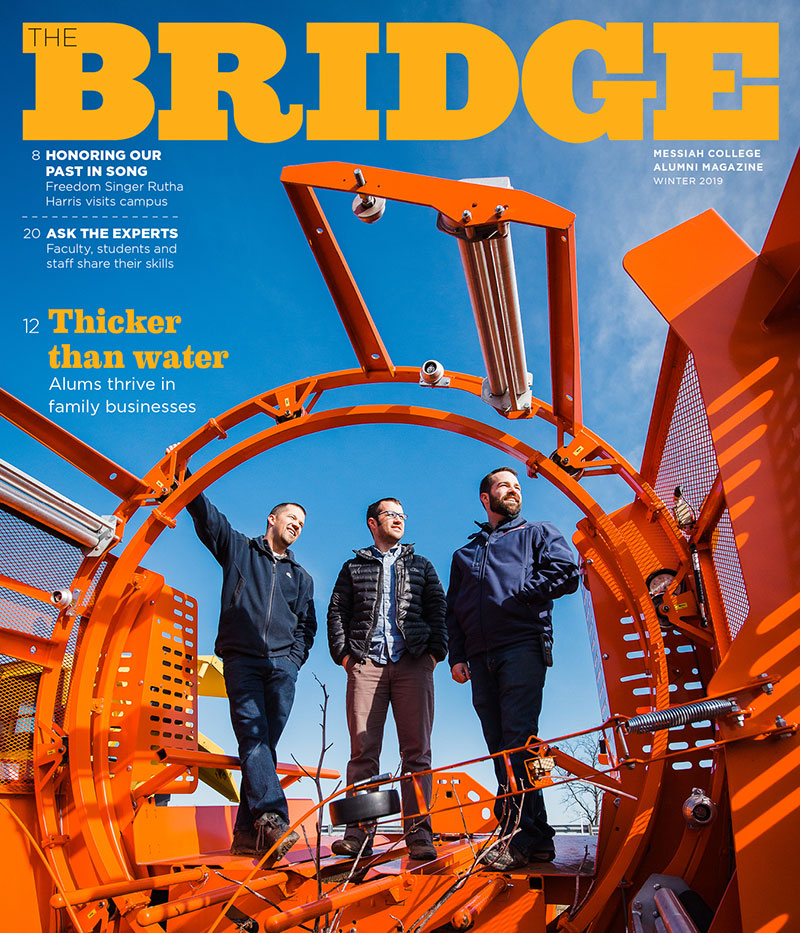Cover of the Bridge, winter 2019.  Three men standing with machinery from feature story.