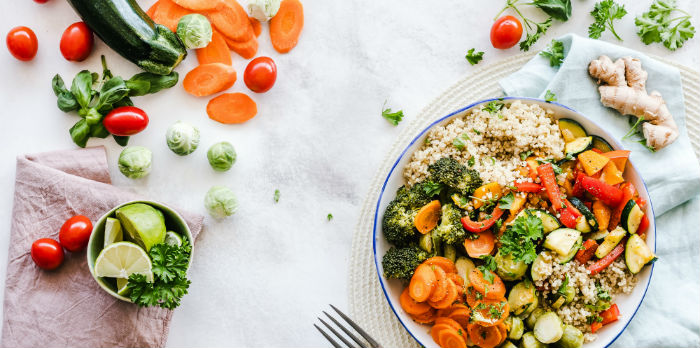 A spread of vegetables in a bowl and on a table are shown.