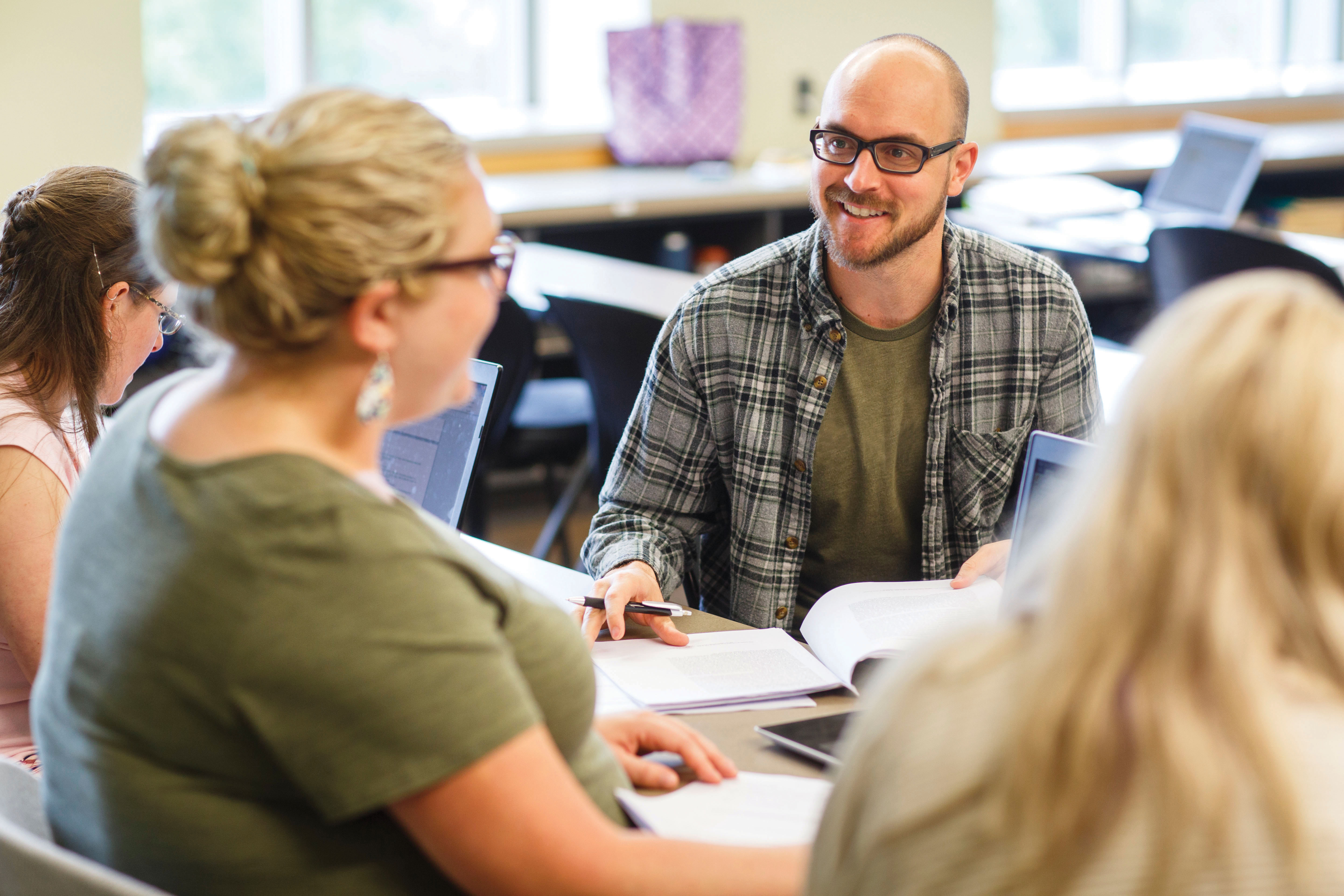 Adult students talking with one another.