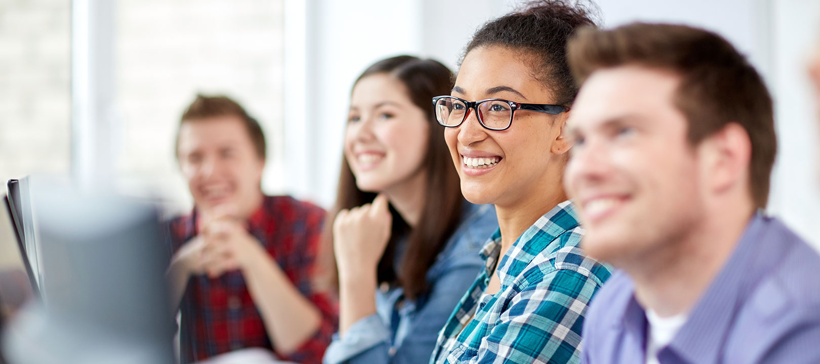 Several students smiling in class