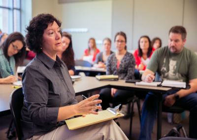 Students listening to lecturer in class.