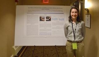 Haley Wilson standing beside her presentation poster.