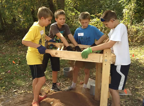 Children examining dirt.