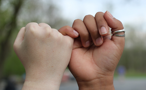 Hands making a "pinky promise"