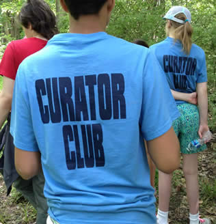A student wearing curator club 2 shirt
