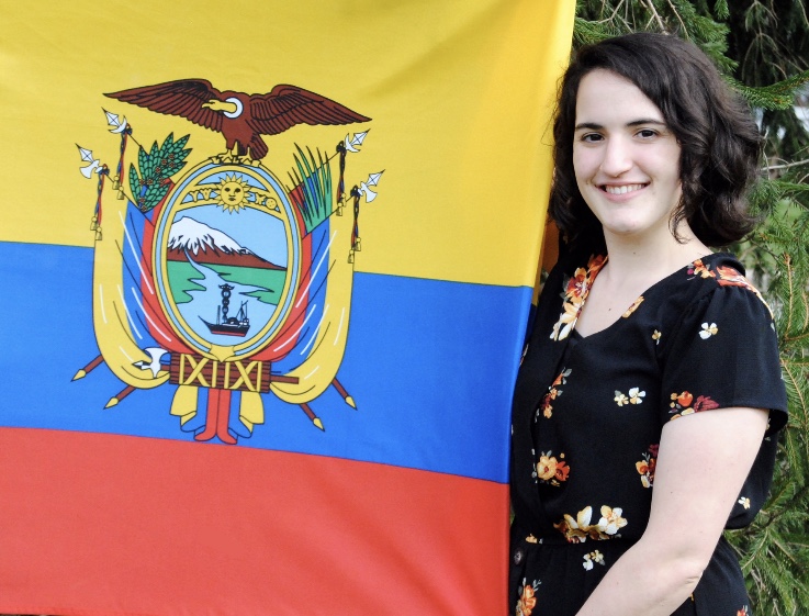 Marissa Donlevie stands by the flag of Ecuador
