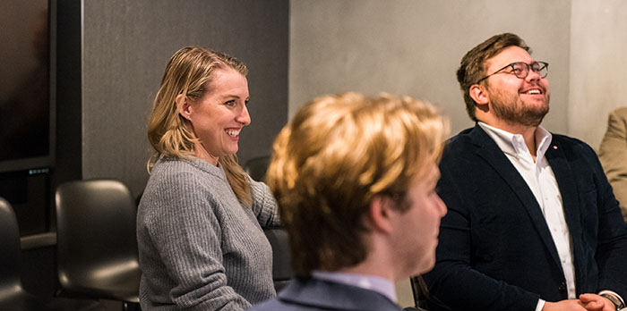 Three business people sit together in a room.