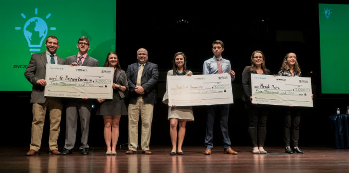 Winners from the IVC competition in 2018 stand together on stage.