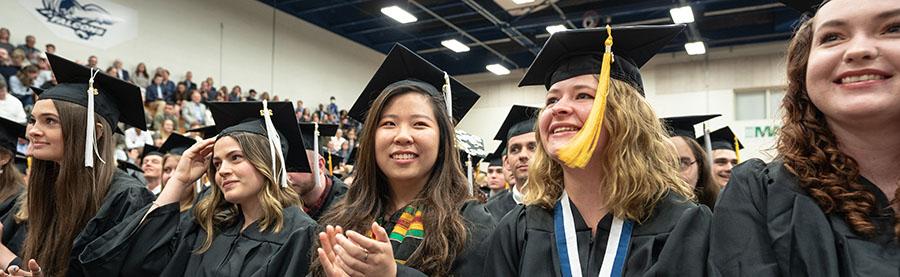 Grads indoor commencement ceremony Brubaker