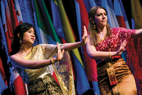 Two students perform on stage at a multicultural event